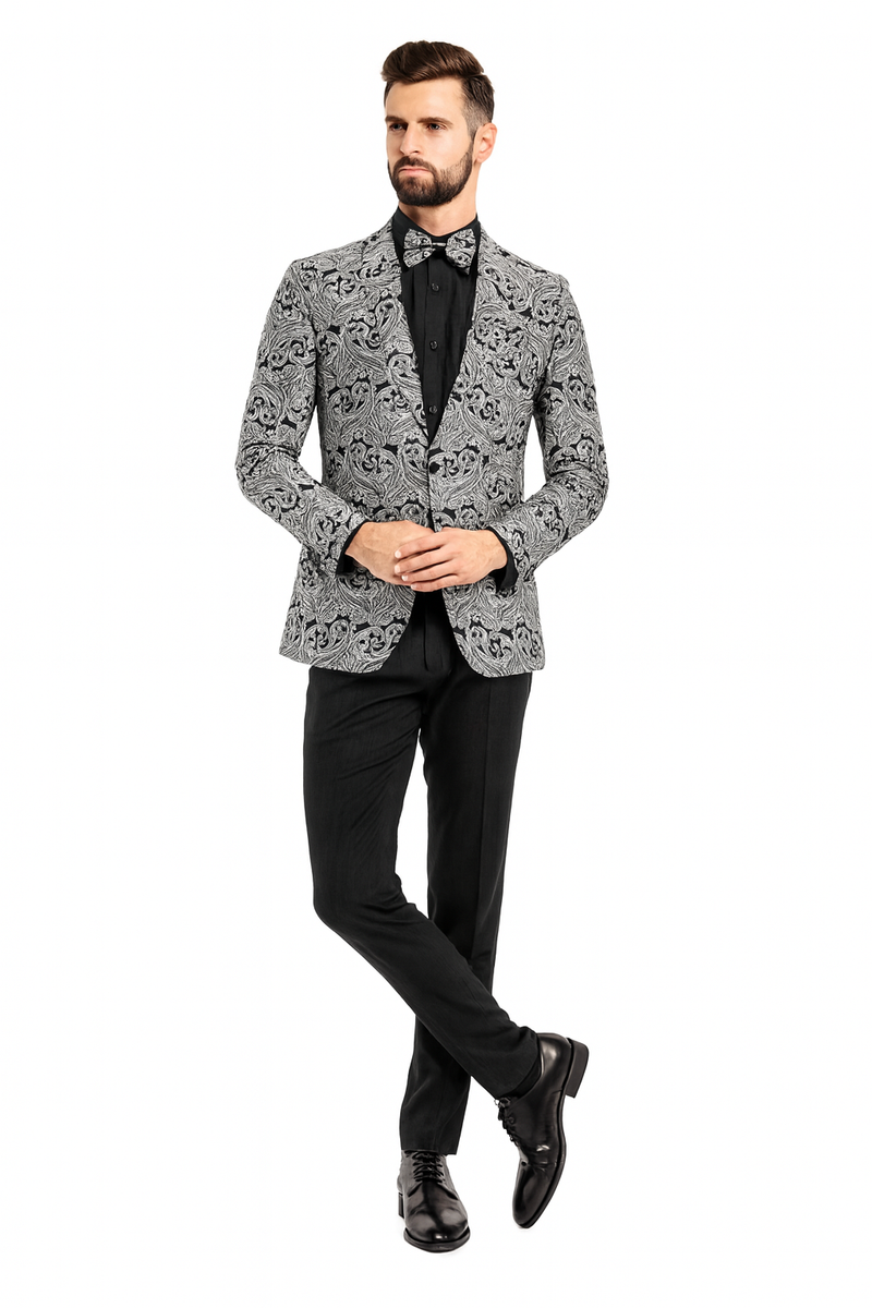 Men's slim-fit black & silver paisley tuxedo jacket. Features a patterned exterior, single-button closure, and is styled with a matching bow tie and black pants.