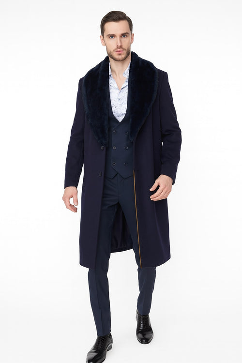 Men's navy overcoat with long silhouette, faux fur collar, and single-breasted front. Solid navy fabric, long sleeves. A gold detail is added on the side seam.
