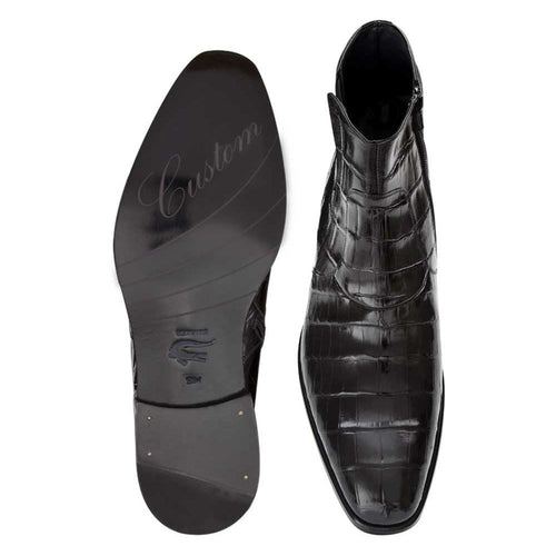 Belucci black alligator boots: ankle height, pointed toe, smooth finish. Black alligator upper with scale pattern. Black sole, embossed "Custom." Side zipper for easy wear.
