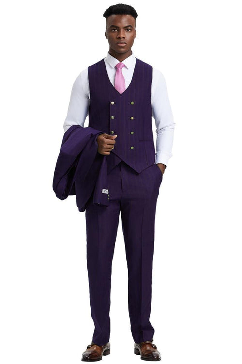 Eggplant purple Stacy Adams men's suit. One-button blazer, fitted vest (double-breasted, gold buttons), pinstripe trousers. Sharp silhouette, tailored look. Includes matching pants. Worn with a white shirt and pink tie.