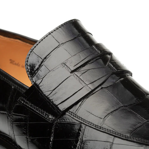 Mezlan's Piccolo Black Penny Loafer: Smooth black genuine alligator leather upper with classic penny loafer design. Features glossy alligator skin patterns and tan interior lining.
