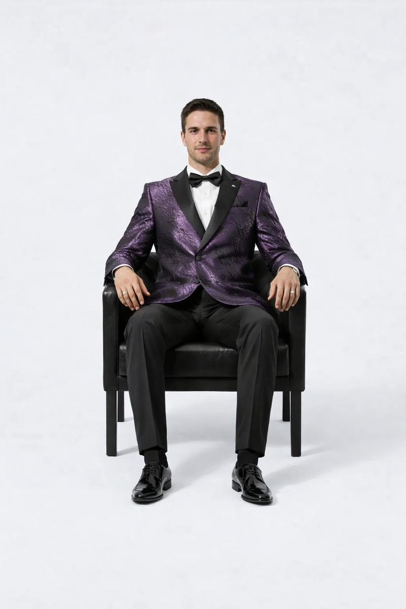Men's purple jacquard tuxedo jacket with black satin peak lapel. Textured pattern, paired with black trousers and shoes. Formal and stylish.