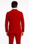 Men's slim-fit red velvet suit. Double-breasted with peak lapels. Smooth texture, tailored silhouette. Jacket: two back vents, buttoned cuffs. Monochromatic red.