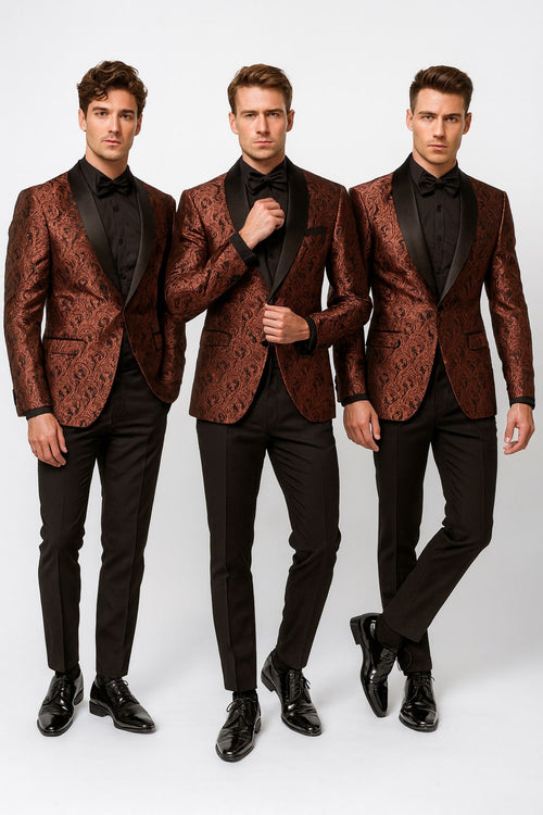 Men's rust copper brick tuxedo jacket with paisley pattern, shawl lapel, and black pants. Matching bowtie. Structured design with detailed paisley fabric. Formal, cohesive look with functional pockets and smooth bowtie finish.
