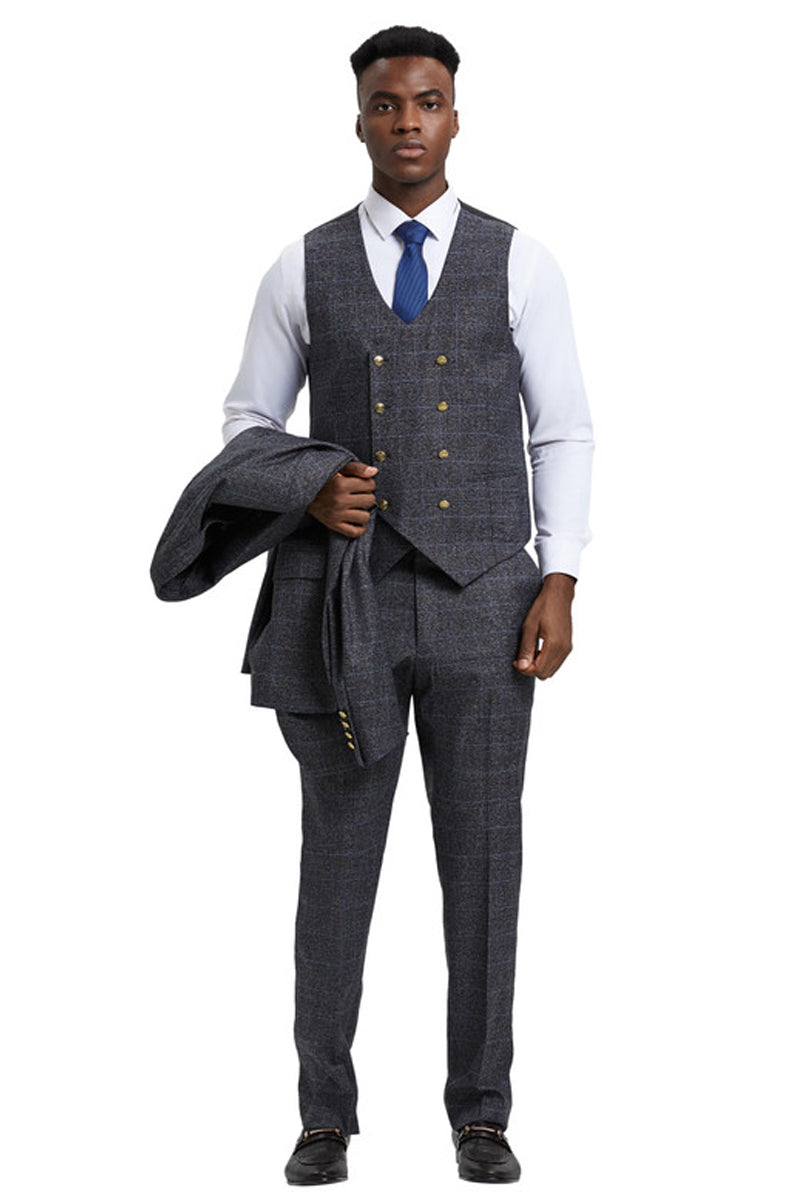 Charcoal grey plaid Stacy Adams men's suit. One-button jacket, peak lapel, fitted design. Includes double-breasted vest, gold buttons, straight-leg trousers. Woven fabric with a checked grey pattern. Formal style.