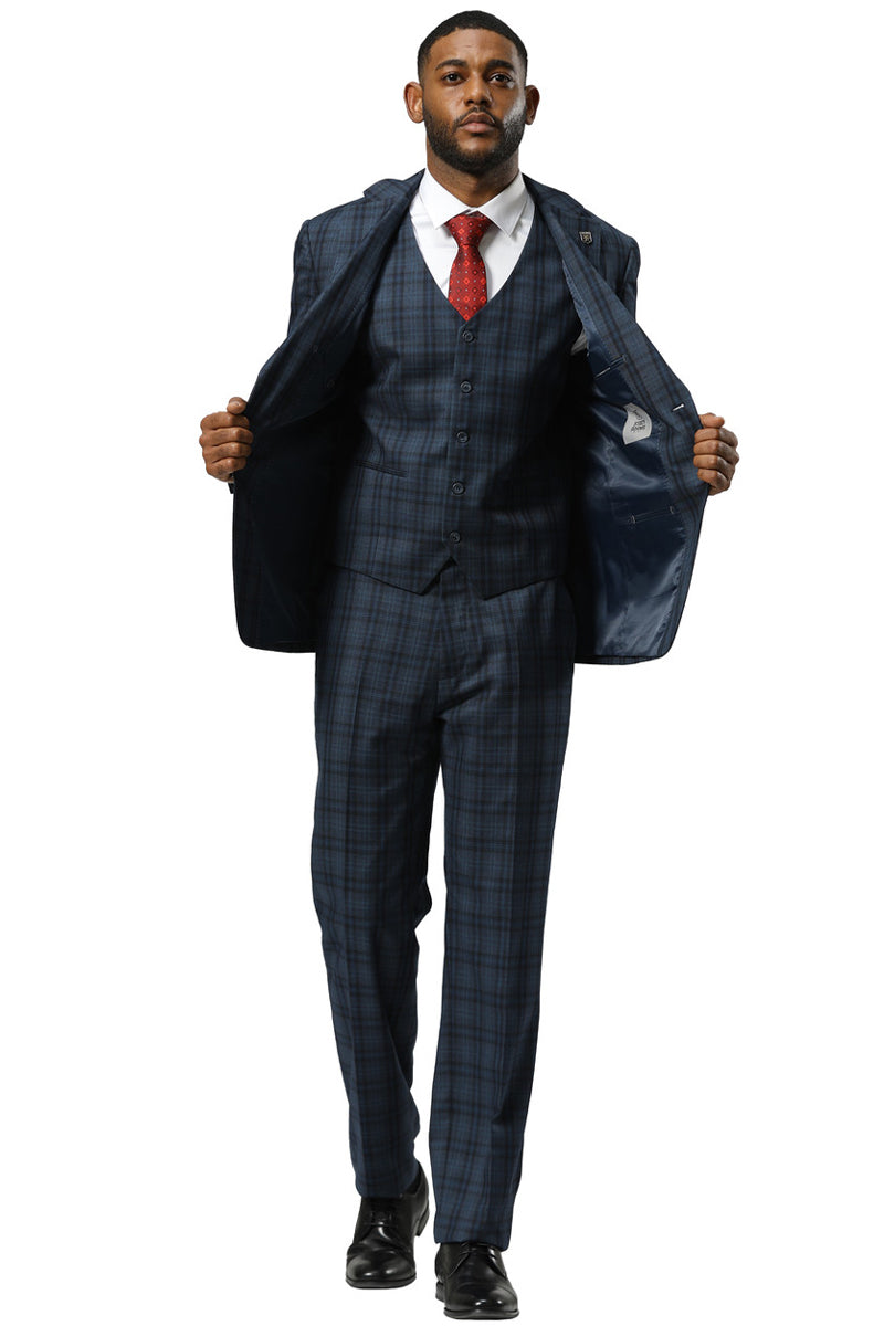 Navy blue Stacy Adams modern fit vested suit with double windowpane plaid. Includes jacket, vest, & pants. Smooth fabric, tailored fit. Jacket open, revealing contrasting lining. Cohesive, pattern-focused design.