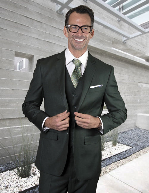 Hunter Green modern fit suit with vest. Two-button closure, pick stitch details, and a tailored silhouette. Smooth fabric for a sleek, rich appearance.
