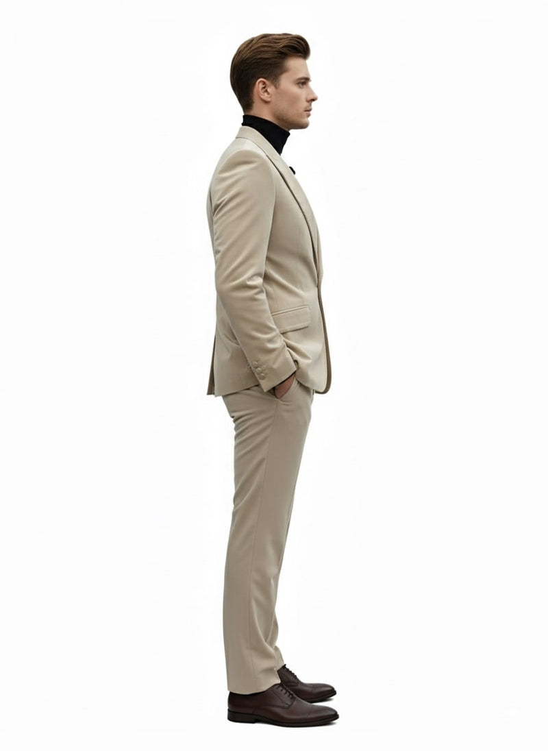 Men's sand beige velvet tuxedo suit. Slim fit blazer with narrow lapels and matching fitted pants. Winter fabric, structured silhouette, tapered ankles. Natural sand beige color.