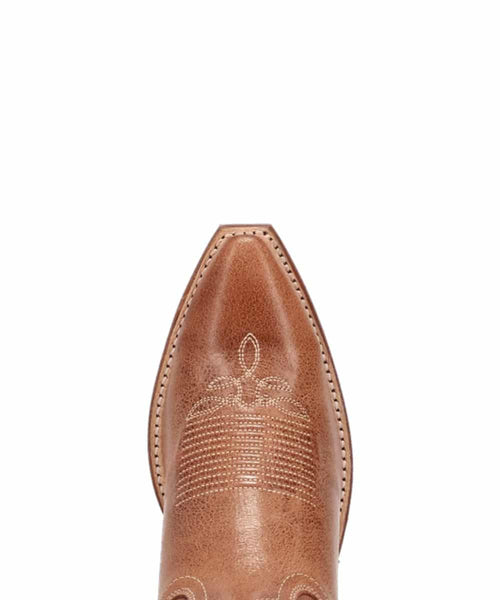 Laredo Serenade women's boot. Light brown leather upper with pointed toe and intricate stitching. Brown sole. Sleek, fitted design; traditional Western style.