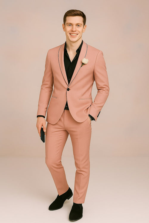 Men's slim fit pink tuxedo with black lapel & pocket trim. Smooth texture, modern silhouette. Jacket & tailored trousers included.