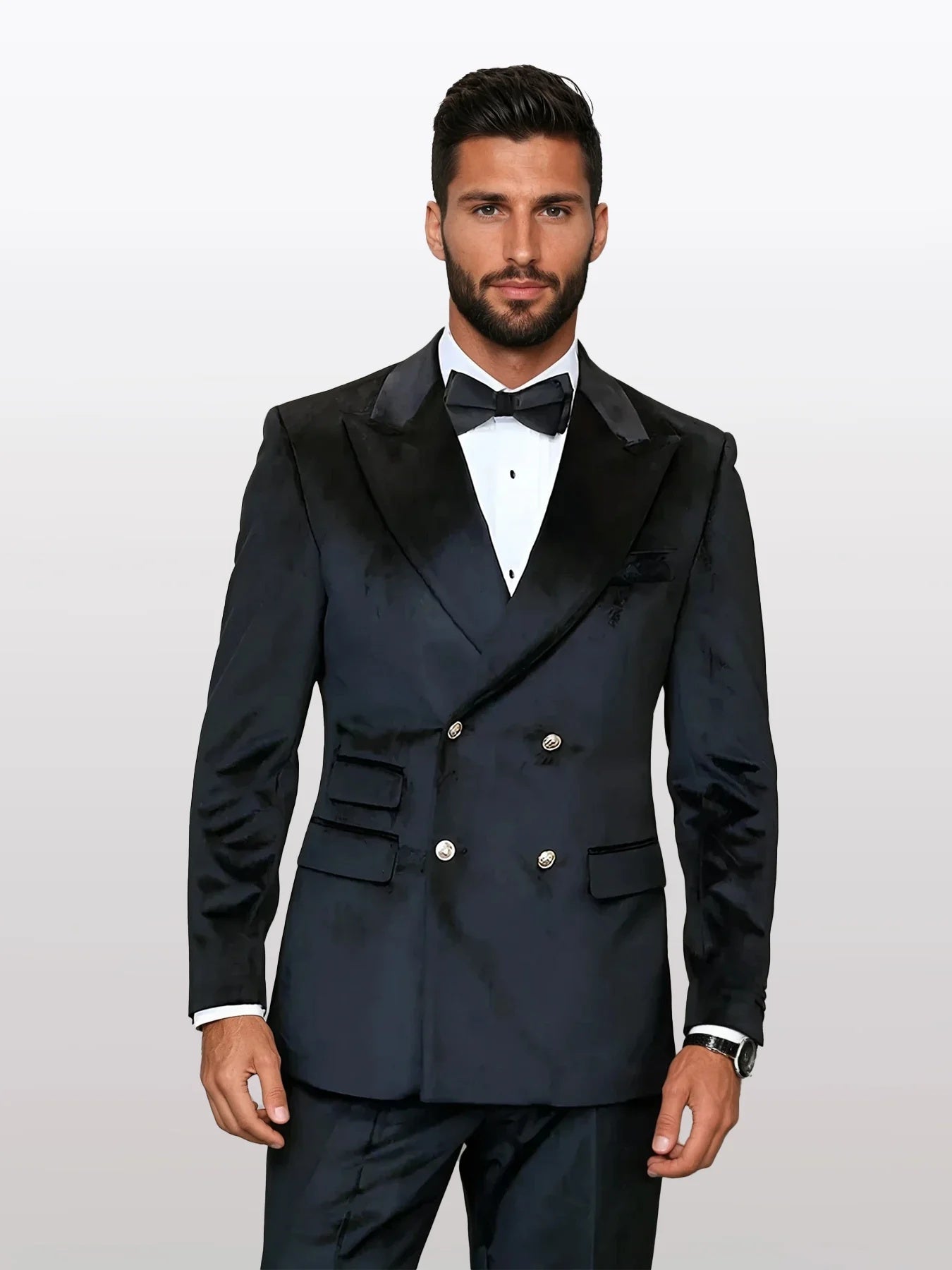 Men's black double-breasted velvet suit features a tailored silhouette with a notched lapel, two rows of gold buttons, and side pockets. The fabric exhibits a soft, luxurious texture.