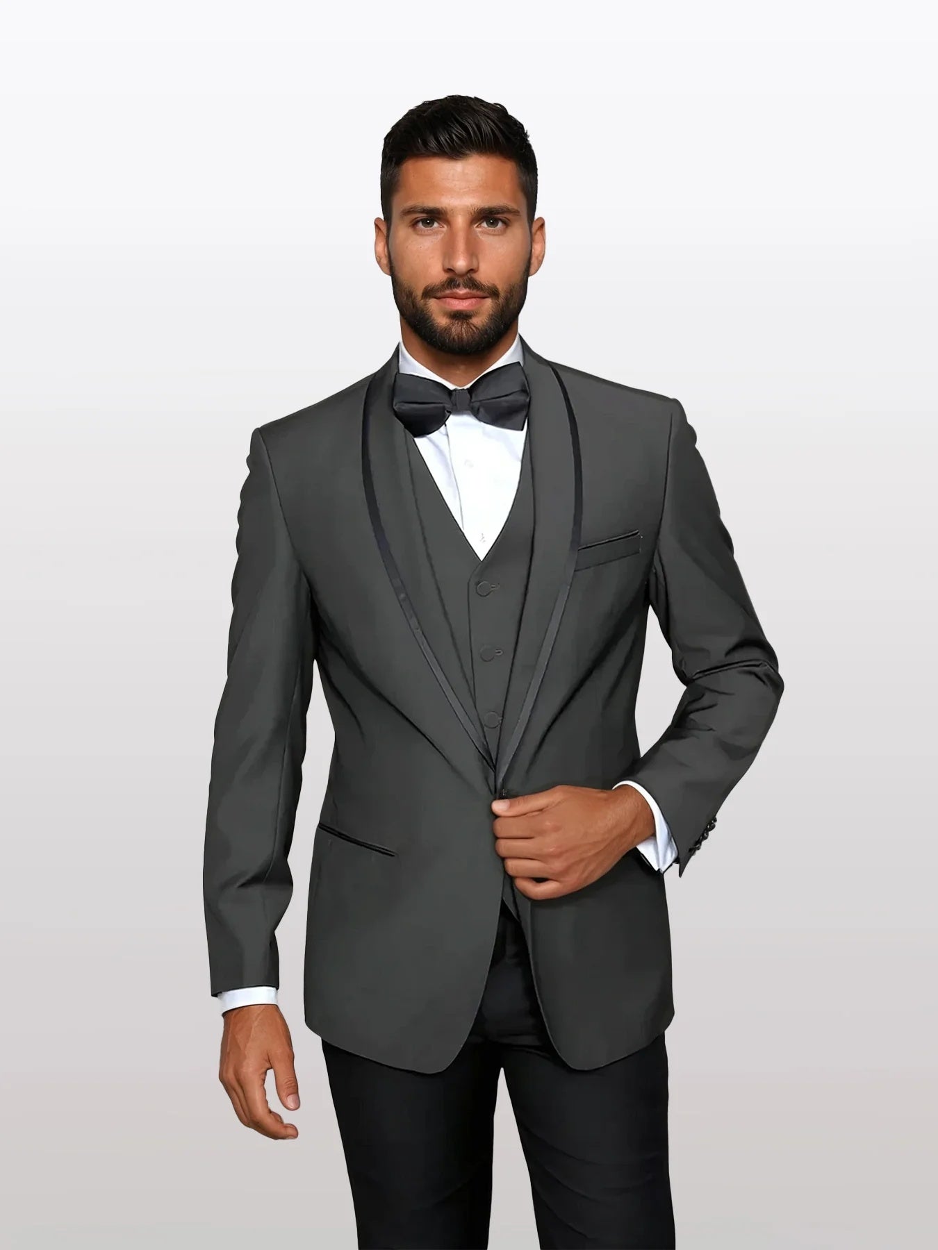 Men's charcoal grey vested tuxedo featuring a single-button closure and peaked lapels. The tuxedo is paired with a black bow tie and a white dress shirt. The vest has a three-button front and pocket detailing.