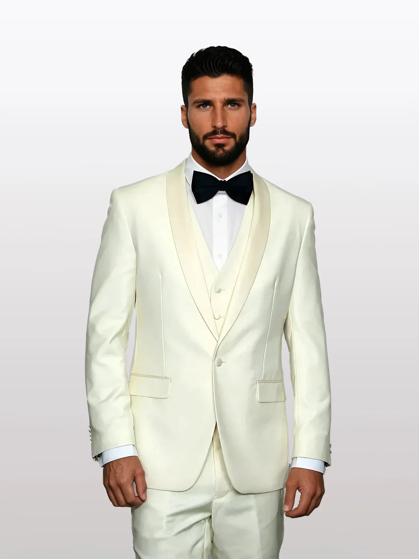 Beige wool tuxedo featuring a white satin lapel and a five-button vest. It includes front pockets and is tailored for a fitted silhouette.