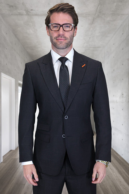 Black windowpane plaid wool suit for men. Slim fit, two-button, peak lapel jacket. Textured wool fabric with subtle plaid pattern. Single-breasted design.