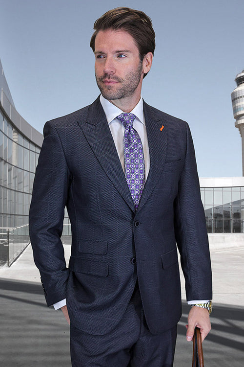 Men's dark grey wool suit with windowpane plaid. Two-button, peak lapel jacket, fitted with structured shoulders and pockets. Matching trousers. Textured fabric, classic design.
