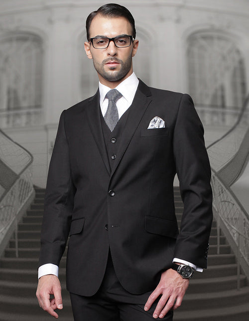 Men's black wool suit: classic fit, 2-button front, pleated pants. Formal style with notch lapels, flap pockets. Includes white pin-dot shirt, patterned tie, and pocket square.