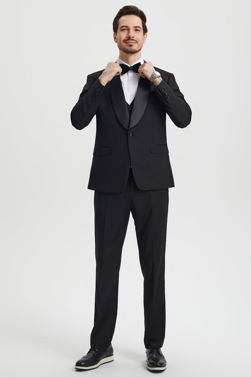Stacy Adams men's black one-button tuxedo with shawl lapel. Fitted jacket, flat-front trousers, and a structured silhouette. Features smooth, solid black fabric and satin details.