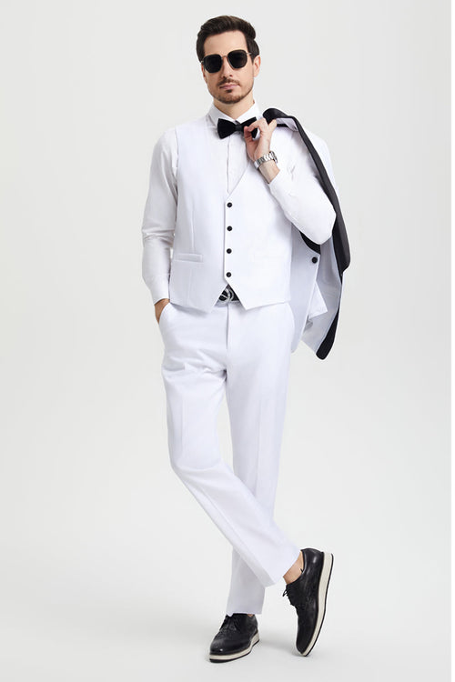 Stacy Adams white tuxedo: one-button jacket with shawl lapel. Fitted vest with black buttons. White, straight-leg trousers. Includes black bow tie. Formal attire.