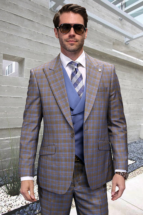 Men's taupe windowpane plaid wool suit. Features a tailored fit, peak lapel, and vest. Plaid pattern in taupe with blue lines. Structured shape. One-button closure.