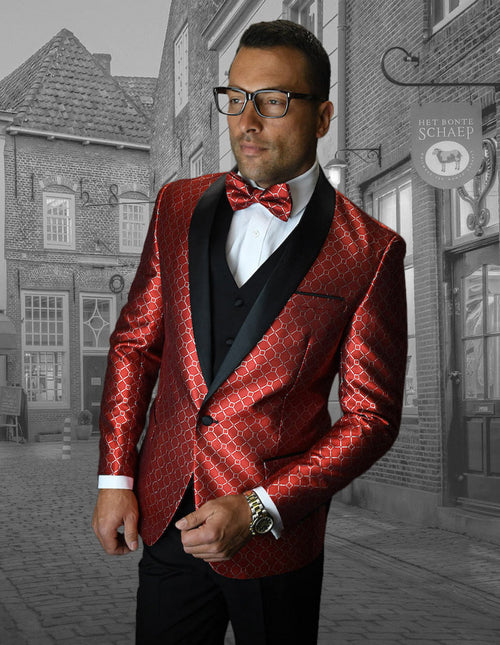 Men's one-button shawl tuxedo with geometric red chain print & glossy finish. Black shawl collar, matching vest, & contrasting black trousers complete the look.