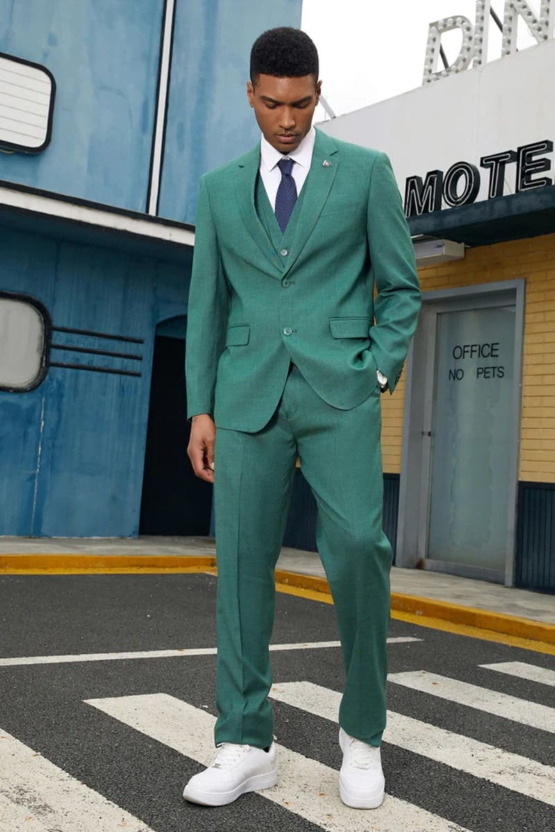 Neon teal men's suit: two-button, tailored fit. Includes matching vest, straight-leg trousers. Lightweight textured fabric with sharp lapels and subtle sheen for a polished look.