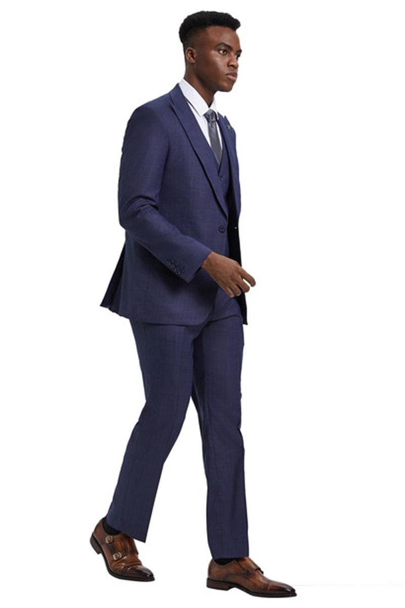 Stacy Adams men's suit: One-button closure, wide peak lapels, and vest. Features an eggplant purple windowpane plaid pattern. Fitted silhouette, smooth blended fabric. Matching tapered trousers.