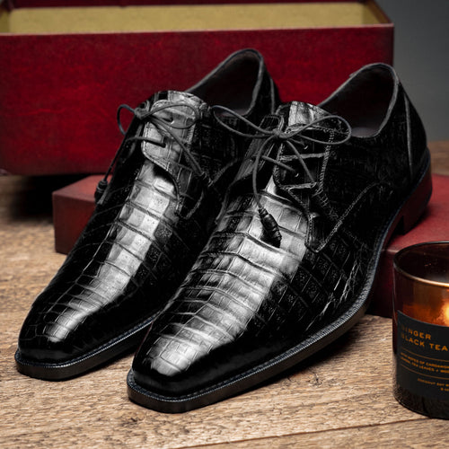 Black Mezlan Anderson derby shoes with a crocodile skin texture. Polished finish, pointed toe, and lace-up closure. Flat, contrasting durable sole.