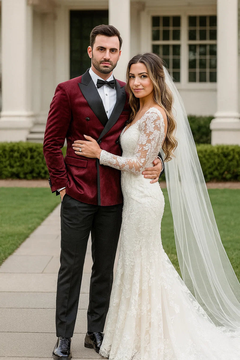 Burgundy velvet double-breasted tuxedo jacket with satin shawl collar. Features black buttons, flap pockets, and a tailored, fitted silhouette. Rich color and smooth texture.