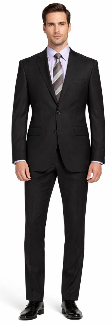 Carlo Lusso black suit: tailored fit, poly blend. Two-button jacket, notch lapels. Straight leg trousers. Solid black, smooth finish with subtle sheen. Flexible, structured silhouette.