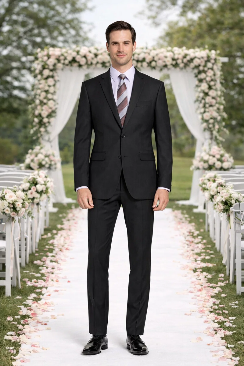 Carlo Lusso black suit by Albertonardoni. Tailored fit, single-breasted jacket with two pockets. Straight-leg pants. Poly blend with a subtle sheen. Worn with a light shirt and diagonal striped tie.
