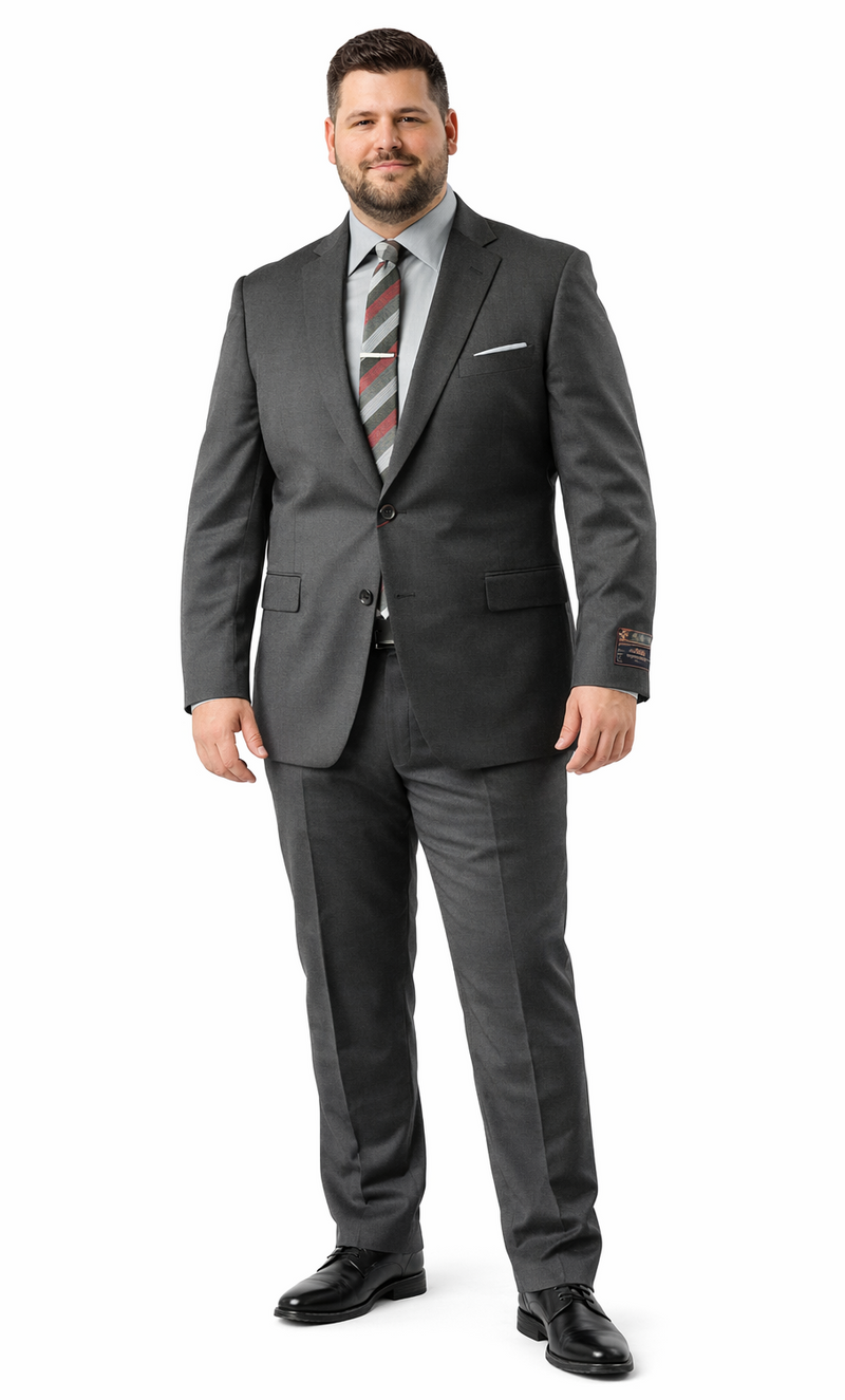 Carlo Lusso charcoal slim fit suit: two-button, single-breasted jacket, matching trousers. Poly blend, solid charcoal, smooth finish. Jacket: two front pockets, welt chest pocket. Trousers: flat front, slim fit.