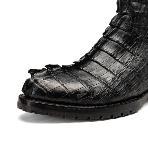 Marco Di Milano Marlboro cowboy boots in black with hornback crocodile tail leather and a tractor sole. Pointed toe, textured design for rugged wear.