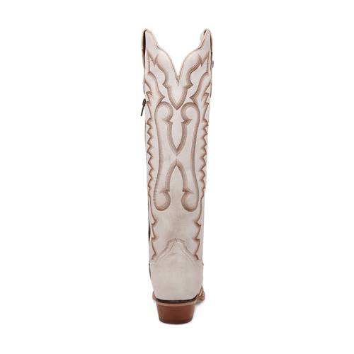 White Dan Post Josie boots. Tall shaft, snip toe, and small heel. Decorative tan stitching in swirling side pattern. Crafted from smooth leather.