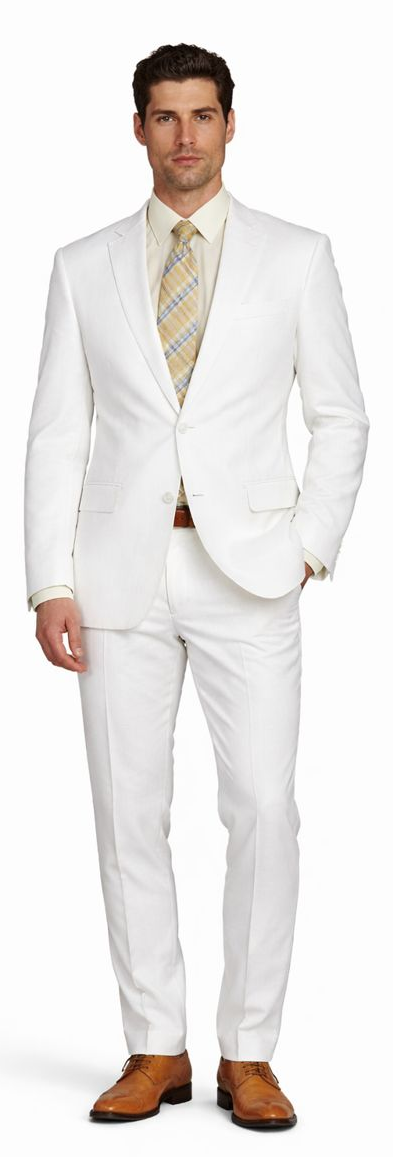 White linen suit: single-breasted jacket with notched lapels, straight-cut trousers. Lightweight, breathable fabric. Paired with a light shirt and patterned tie. Clean, tailored look.
