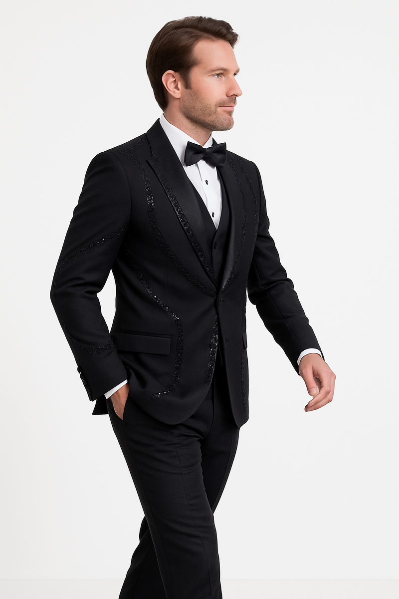 Modern-fit black three-piece tuxedo. Structured silhouette with satin lapel and sequined accents on the jacket. Black vest. Tailored trousers match the jacket. Cohesive, elegant look.