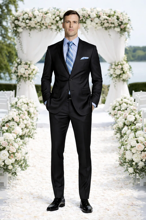 Giorgio Fiorelli black suit with French blue shirt. Tailored black jacket with notch lapels, matching trousers. Light blue shirt, striped tie, pocket square. Fitted, modern silhouette.
