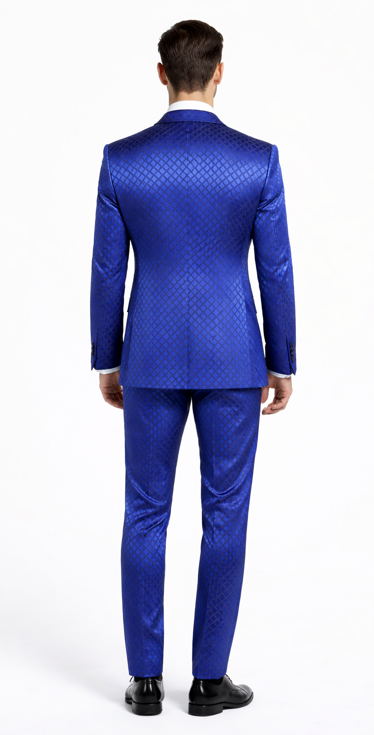 Giovanni Testi navy checkered slim fit tuxedo by Albertonardoni. Vibrant blue with a geometric pattern, structured jacket, peaked lapel, tapered waist, slim trousers. Slight sheen, likely a blend. White shirt contrast.