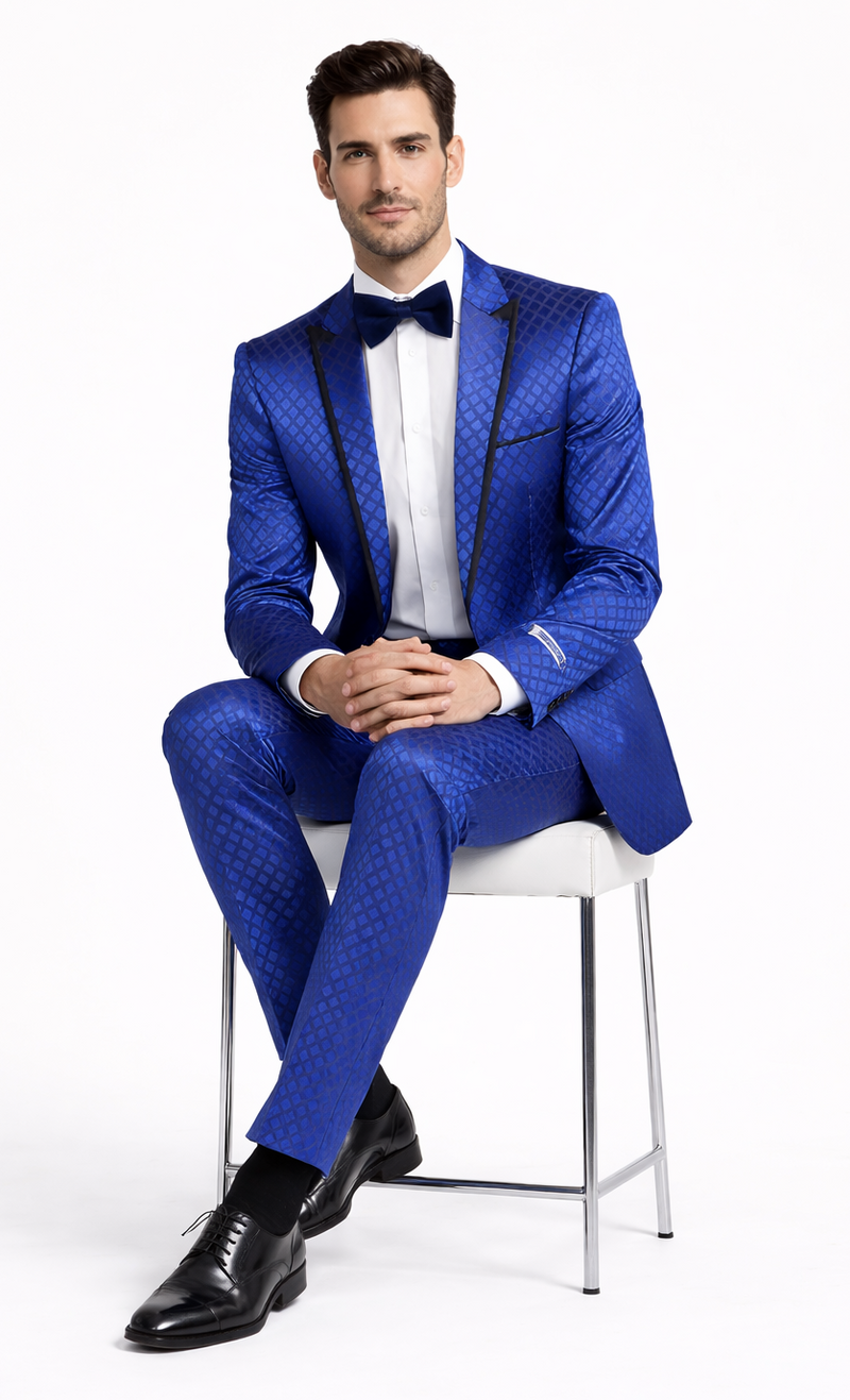 Navy checkered slim-fit tuxedo by Giovanni Testi. Vibrant blue with diamond pattern, black lapels, and tailored silhouette. Glossy fabric, slim-fit trousers.
