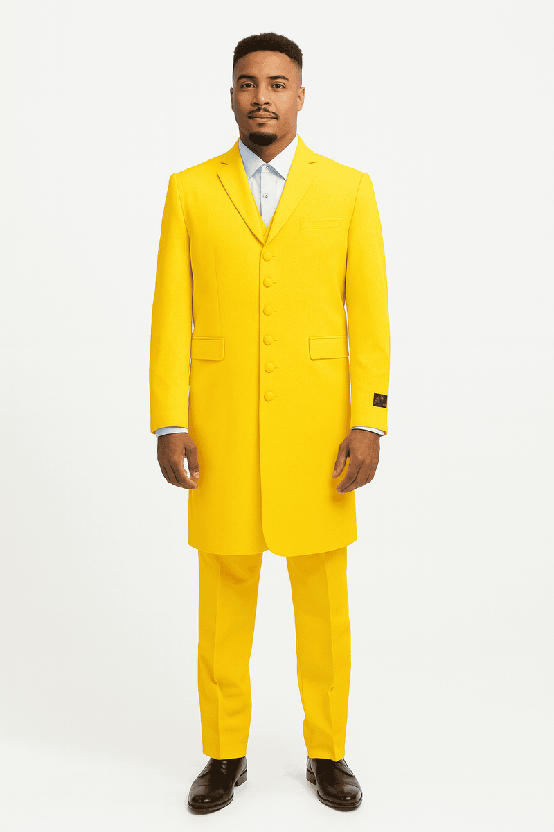 Men's zoot suit in bright yellow, smooth fabric. Features a long, tailored jacket with a notched collar, five buttons, and two pockets. Matching trousers complete the suit. 1920s vintage style, with a light blue shirt peeking through.