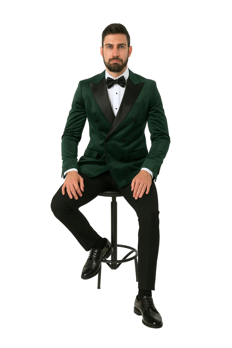 Green velvet double-breasted tuxedo jacket. Rich green hue, soft fabric. Black satin lapels, front buttons. Two pockets, tailored for a structured silhouette.