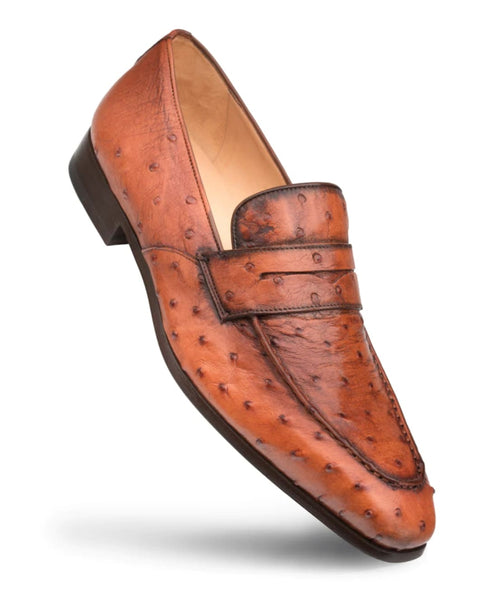 Mezlan's Lisbon Brandy Slip-On: Sleek, low-profile design. Brown, textured ostrich leather with unique patterns. Smooth leather lining. Dual strap vamp. Slightly raised sole.