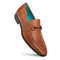Mezlan Rios Flex Loafer in cognac. Smooth leather upper, tapered shape, and decorative metal ornament. Features contrasting turquoise lining and a stable black rubber sole.