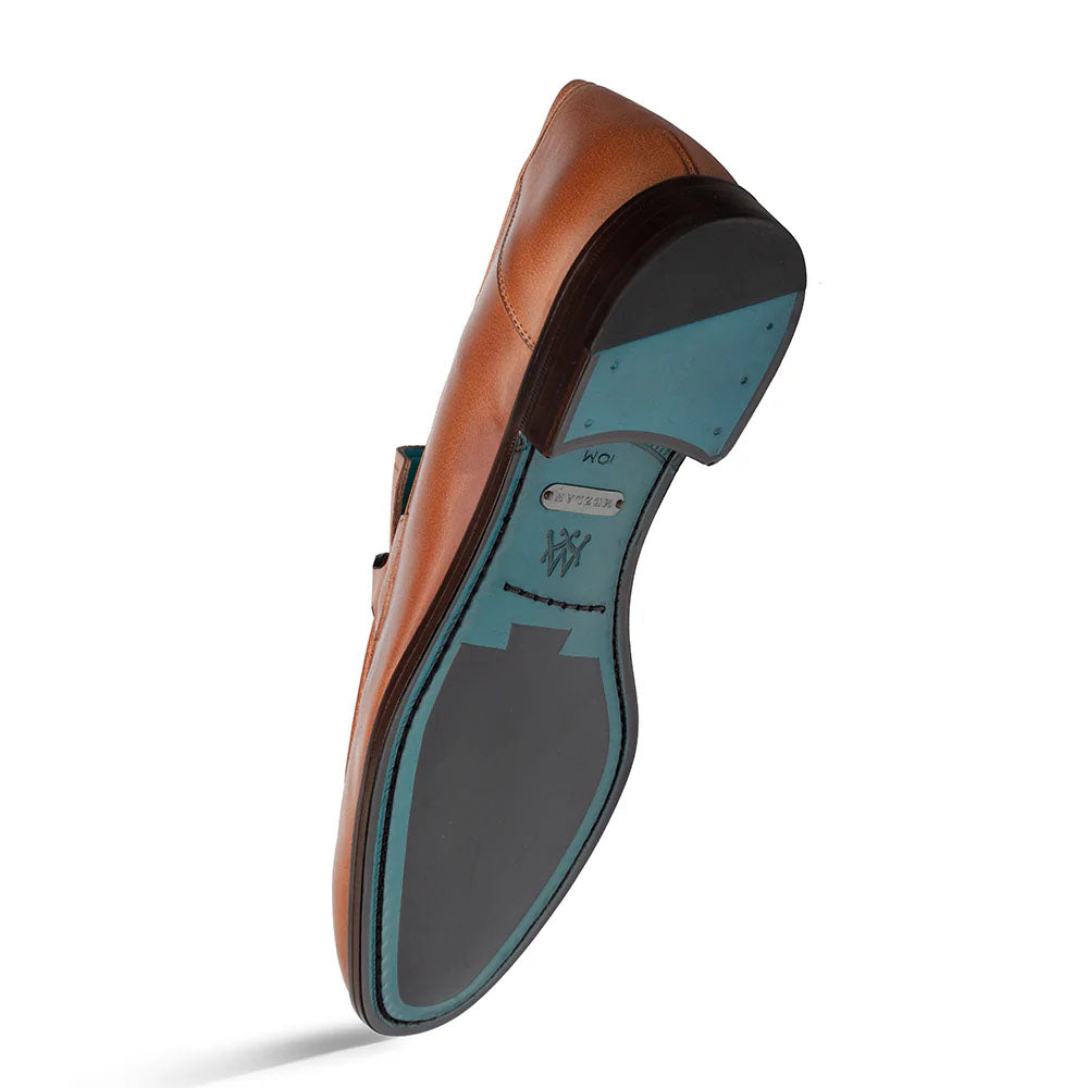Mezlan Rios Flex Loafer in cognac. Smooth leather upper, elongated shape. Contrasting blue interior/black rubber sole for stability. Ornamental detail.