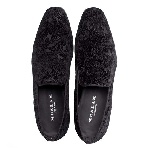Mezlan Travolta loafer: Black velvet with tonal floral pattern. Slim, elongated silhouette, slightly elevated heel. Slip-on design, padded collar, black fabric lining, and rubber sole.