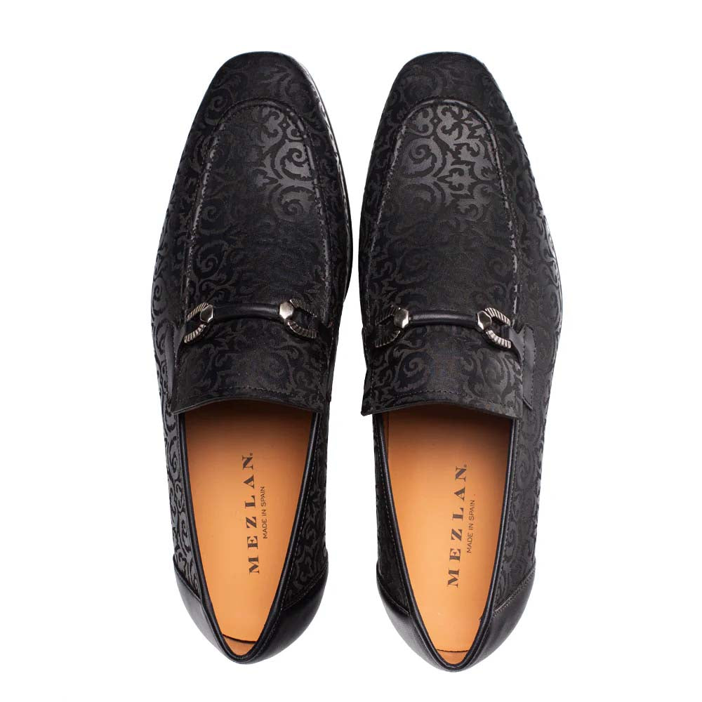 Mezlan Alcaraz slip-on loafer in black leather, embossed floral pattern. Elongated shape, rounded toe, orange lining. Silver details near instep.