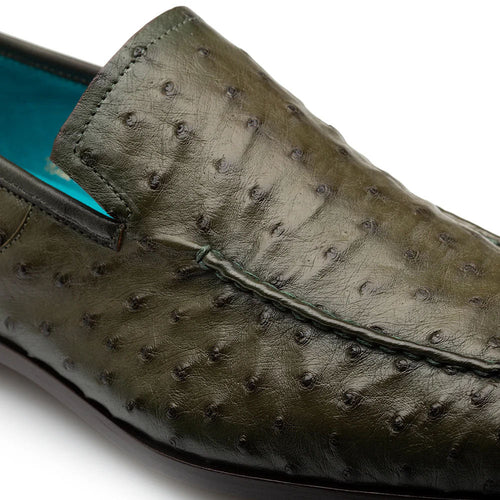 Mezlan Menor ostrich slip-on: olive ostrich leather with unique bumps. Turquoise lining adds contrast. Low-profile, sleek design with a subtle stitched seam. Flat sole.