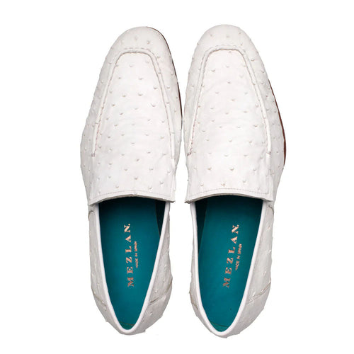 White Mezlan Menor Ostrich slip-on with textured dots. Elongated shape, rounded toe, no laces. Turquoise interior lining with branding. Brown, curved sole.