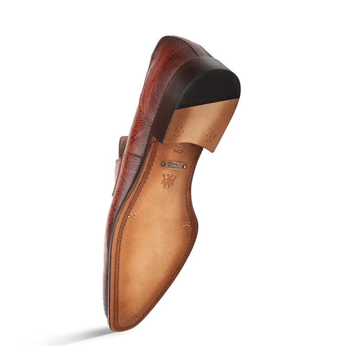 Cognac Mezlan Mayor penny loafer with textured lizard leather upper. Features a rounded toe, slip-on design, and smooth leather sole. Light leather lining and low heel for a polished look.