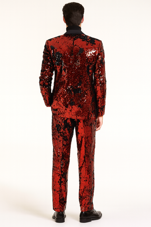 Men's red sequin tuxedo suit: slim fit blazer with black lapel, matching straight-cut pants. Shiny red sequins cover both pieces, creating a textured look. Vibrant, coordinated ensemble.