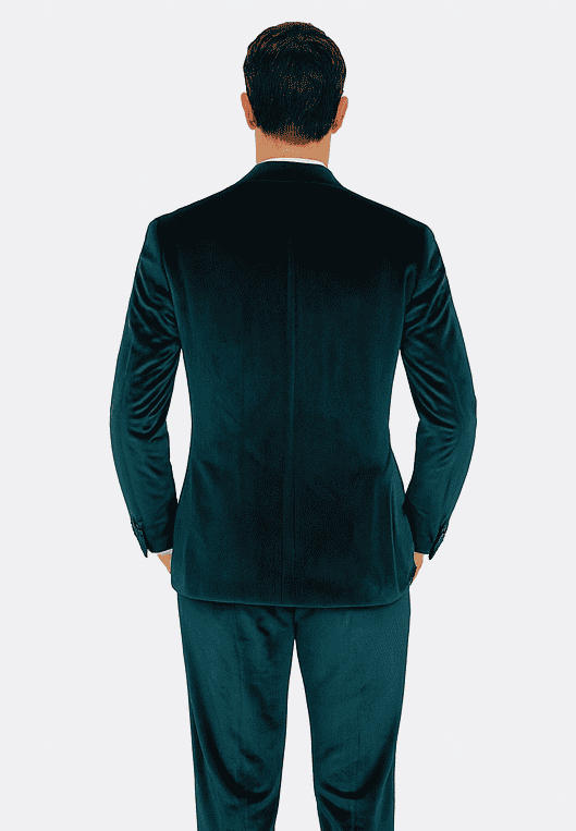 Teal velvet men's suit: two-piece, peak lapel, slim fit. Soft, textured velvet in rich teal. Back view reveals tailored shape, single vent. Sleeves taper, showcasing a refined, slim silhouette.